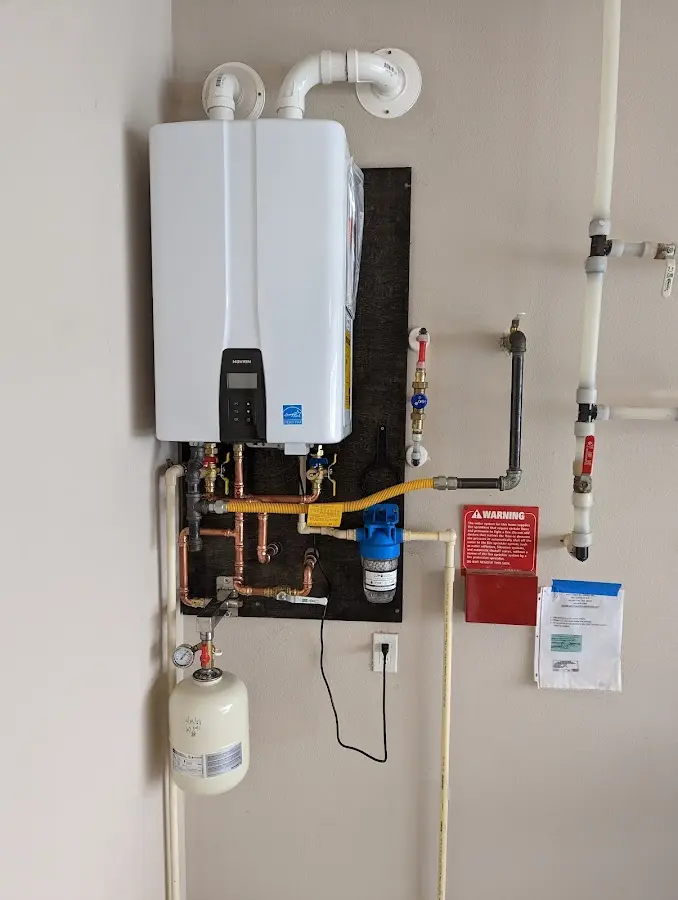 Professional plumber installing copper piping in a Ashland home